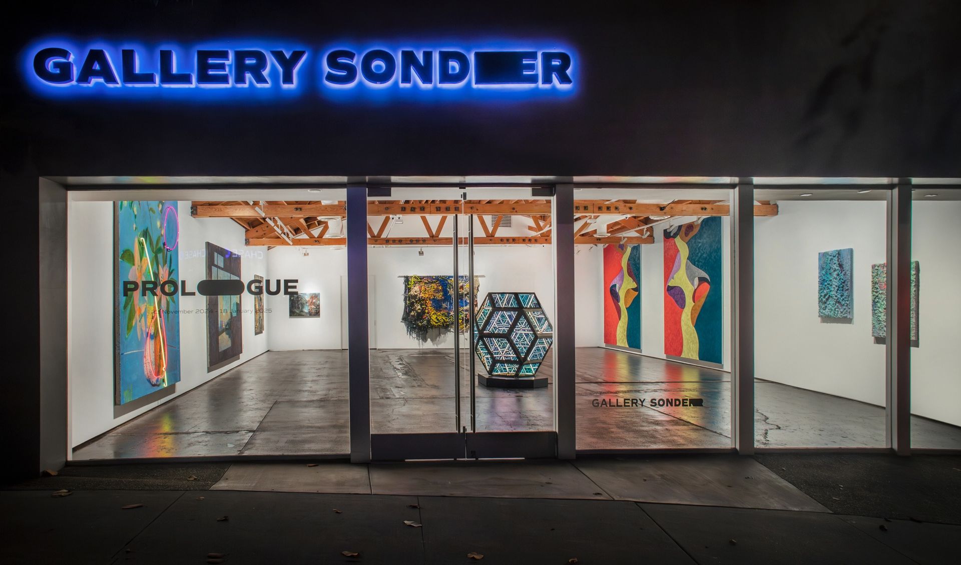 Gallery Sonder storefront lit up at night
